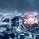 A robotic hand overlaid with technology icons reaches out to "2024" in a bubble.